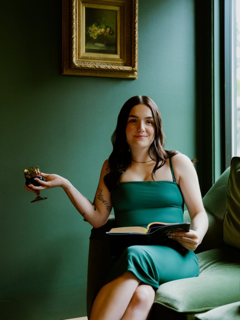 Carmen Garringer settles into the shop’s velvet sofa with a book and a glass of wine.