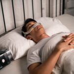 Man sleeping with cpap machine in bedroom