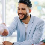 Successful business people handshake in bright mod
