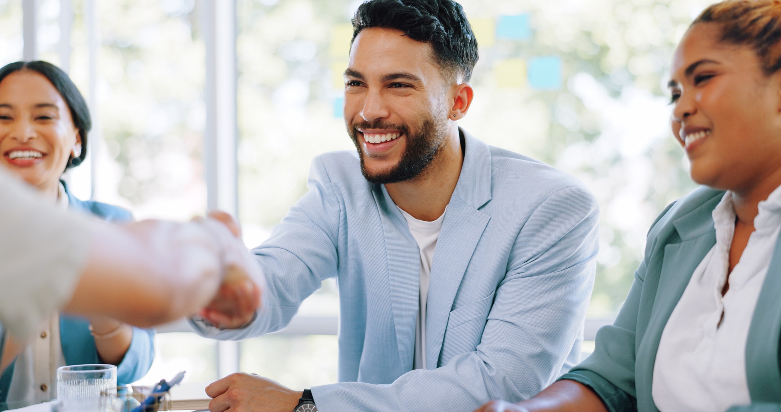 Successful business people handshake in bright mod