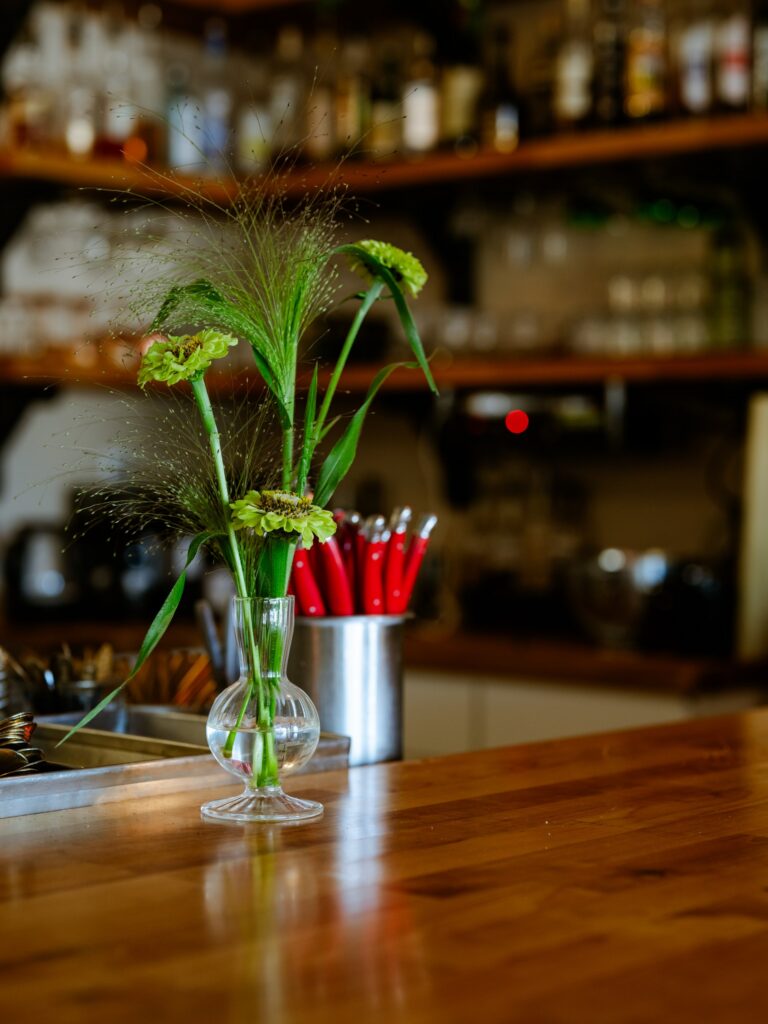 Flowers from Manette Flower Co. add color and character to Restaurant Lola’s dining room.