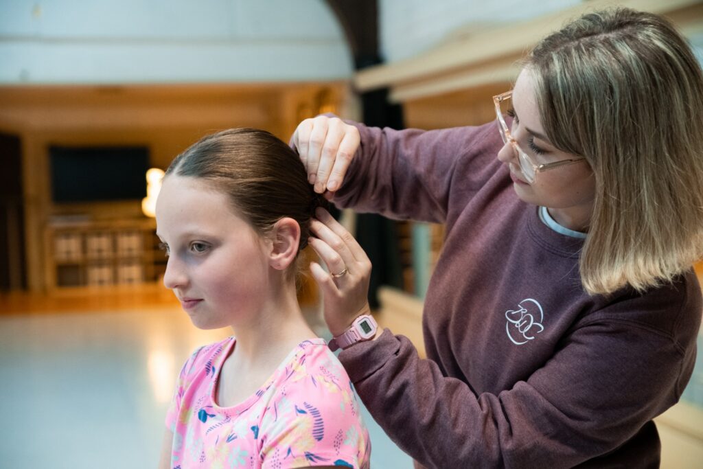 A dancer gets her hair ready for class at Bremerton Dance Center.