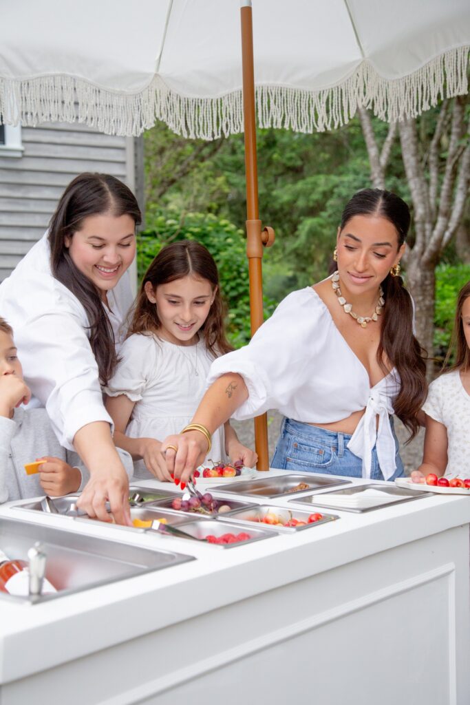Guests enjoy a colorful fruit bar at an event planned by Erickson Event Design.