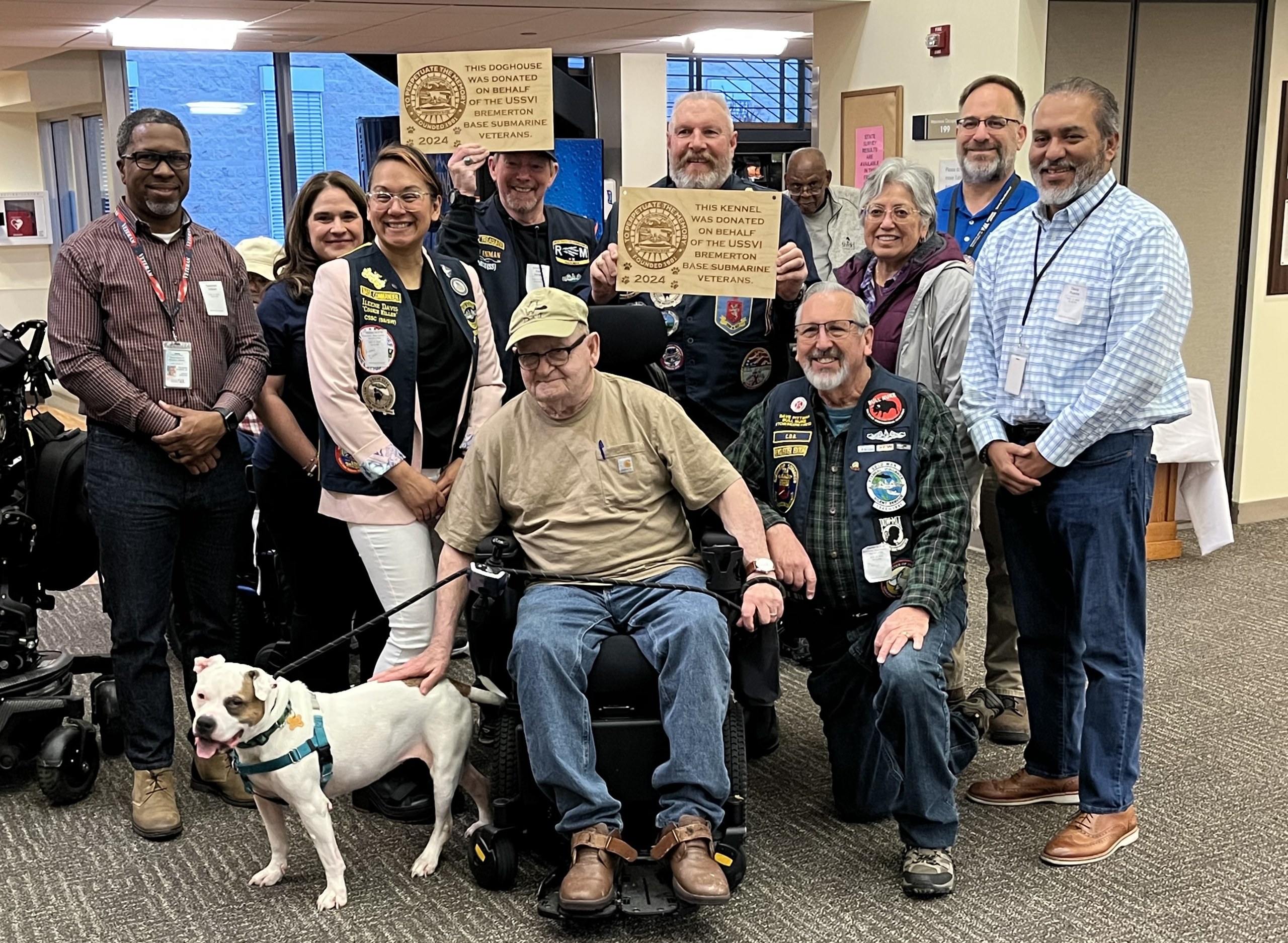 Washington Veterans Home residents, staff and community partners gather with a foster dog at the Port Orchard facility. The resident-run Foster Dog Program, a partnership with Kitsap Humane Society, provides temporary homes and care for senior shelter dogs while helping them find permanent homes. The program recently received a 2026 Abraham Lincoln Pillars of Excellence Award.